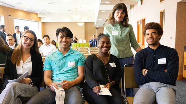 A group of young alumni posing for a photo at a Dartmouth-sponsored networking event.